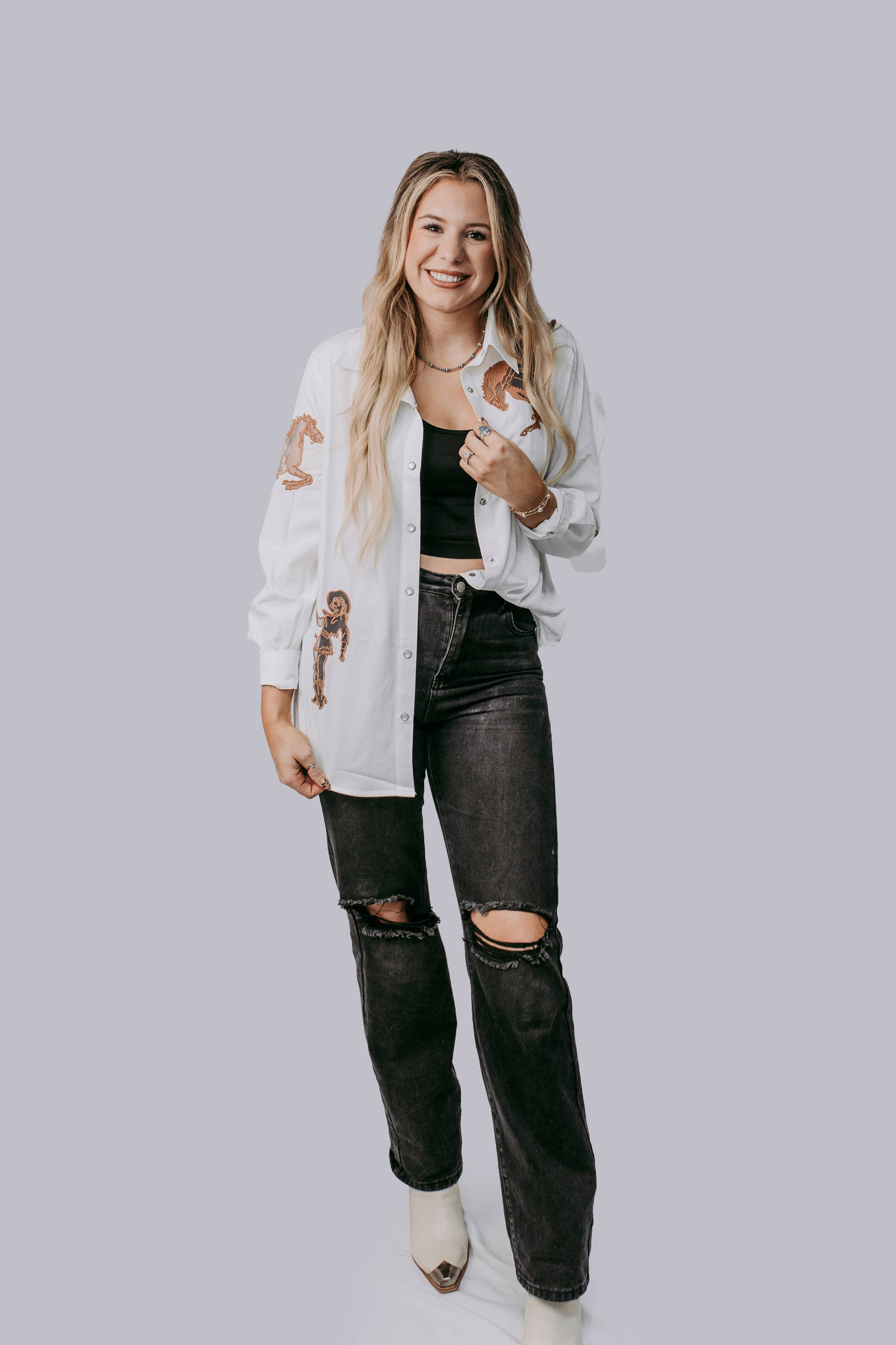 A woman wearing the shirt with a tank and jeans