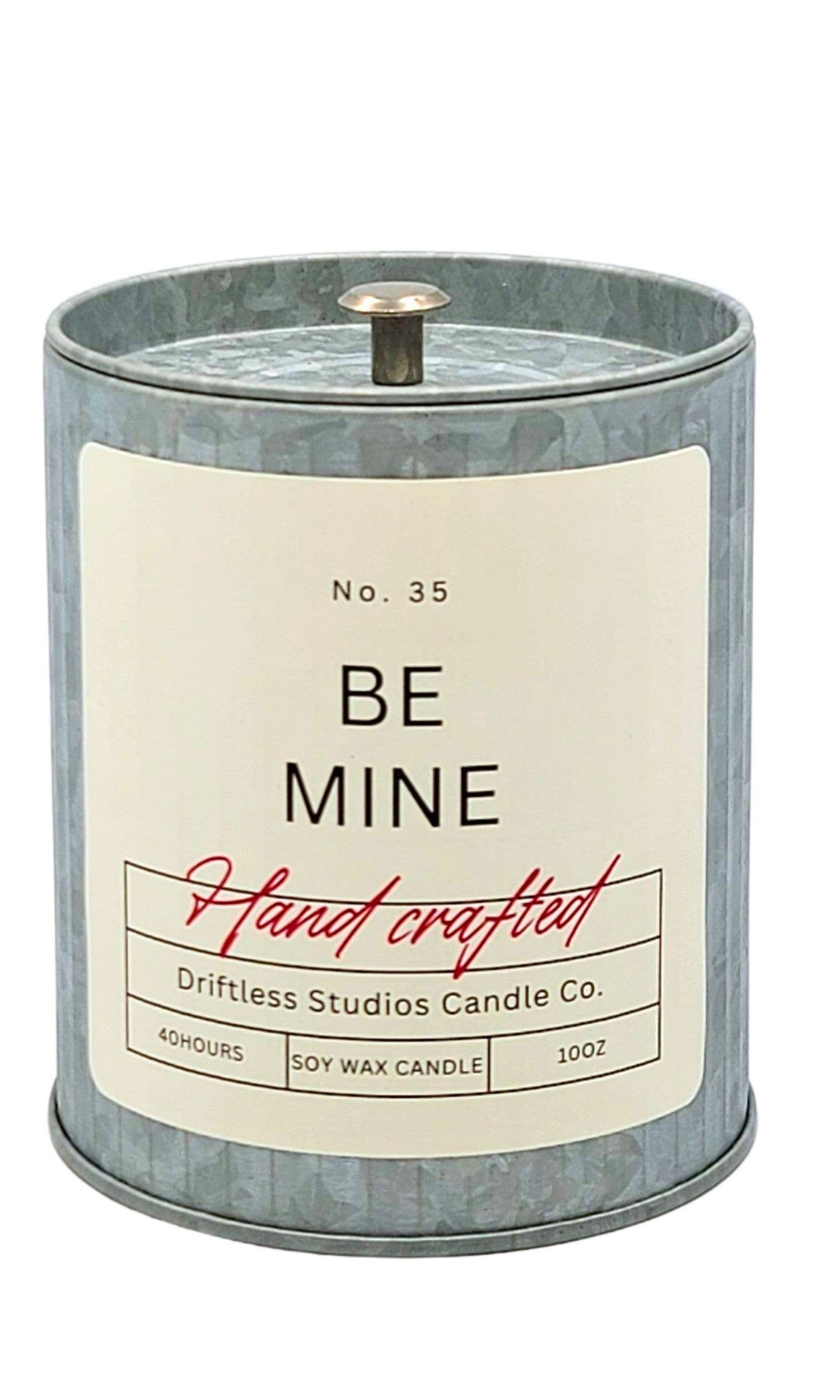 Candle with 'Be Mine' label on a white background