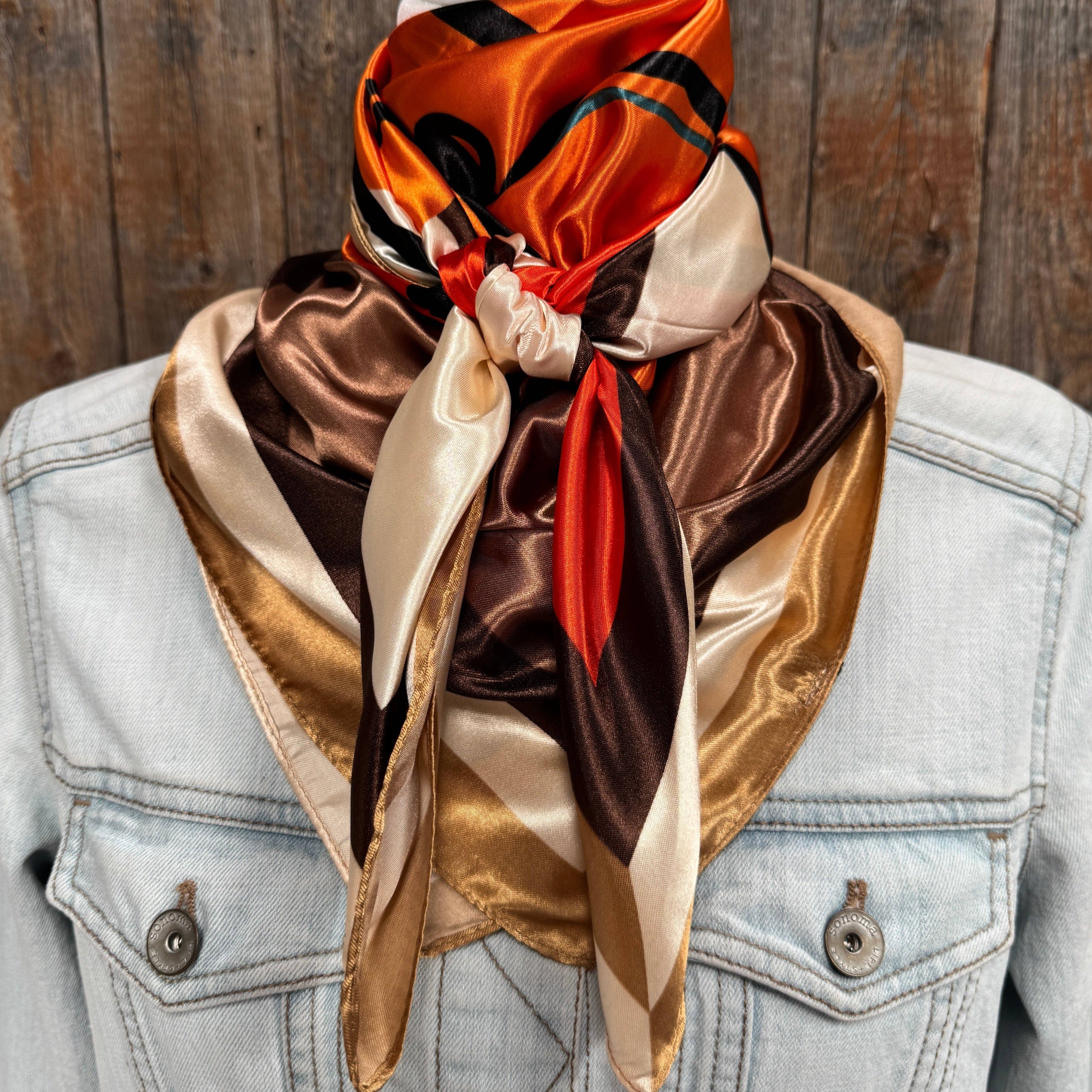Multicolored scarf draped over a denim jacket against a wooden background