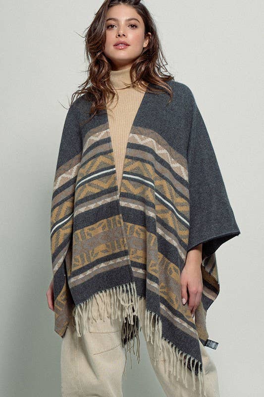 Dark gray poncho with brown and beige striped pattern and fringes on a white background