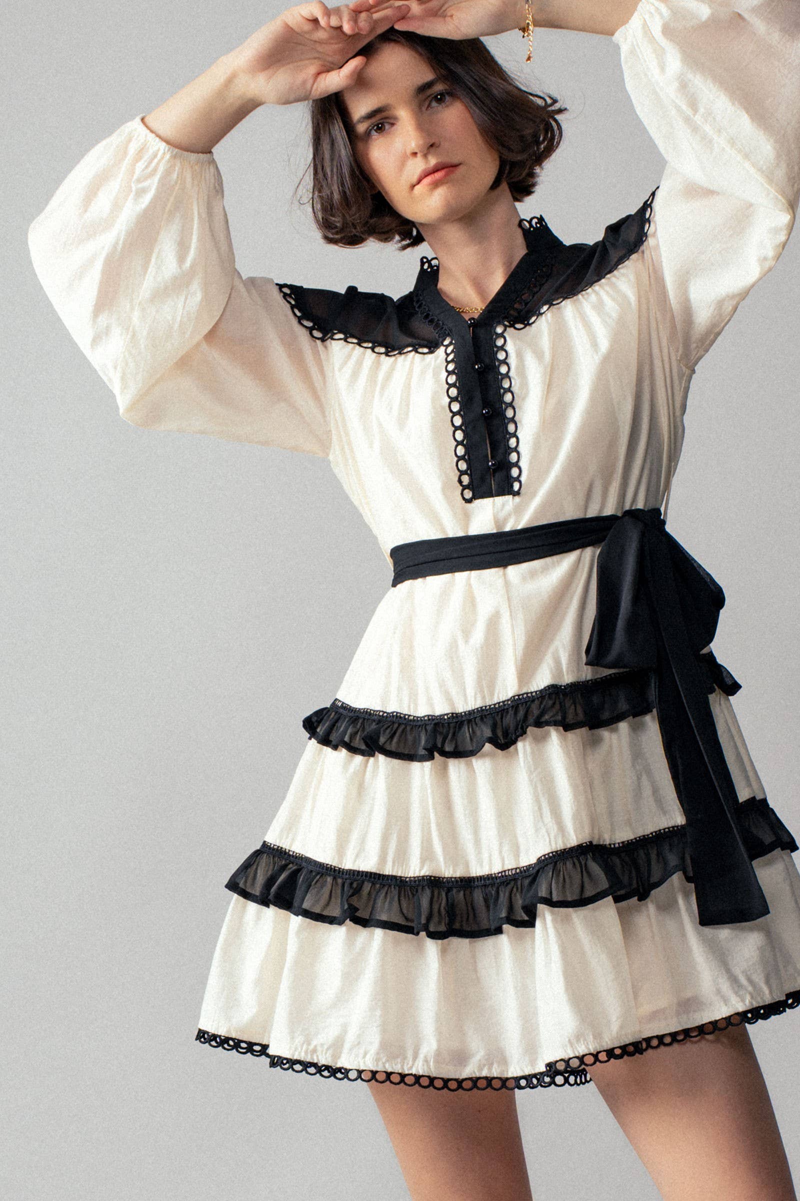 White dress with black accents on a gray background