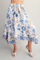 Floral patterned skirt worn by a person on a plain background