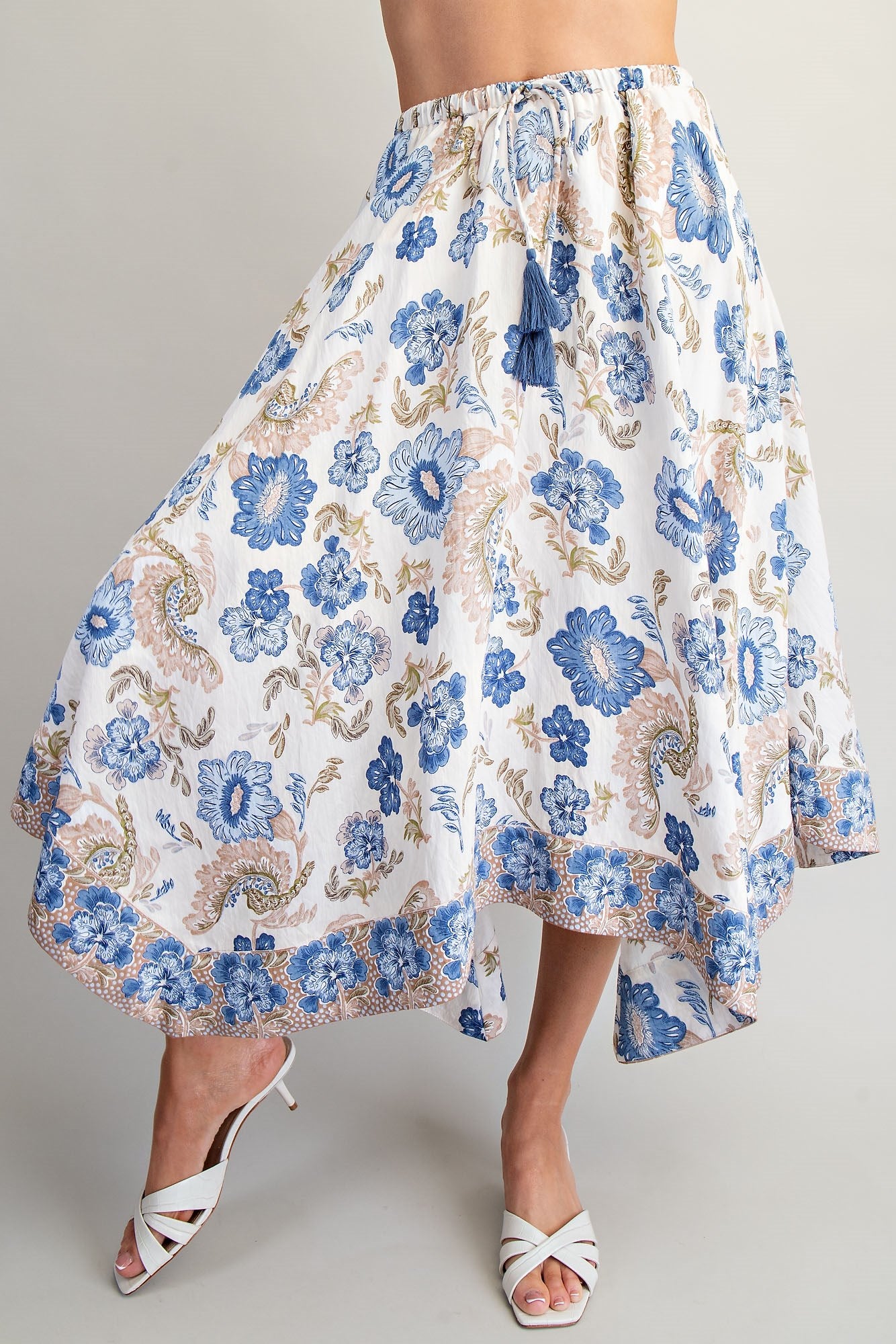 Floral patterned skirt with blue flowers on a plain background