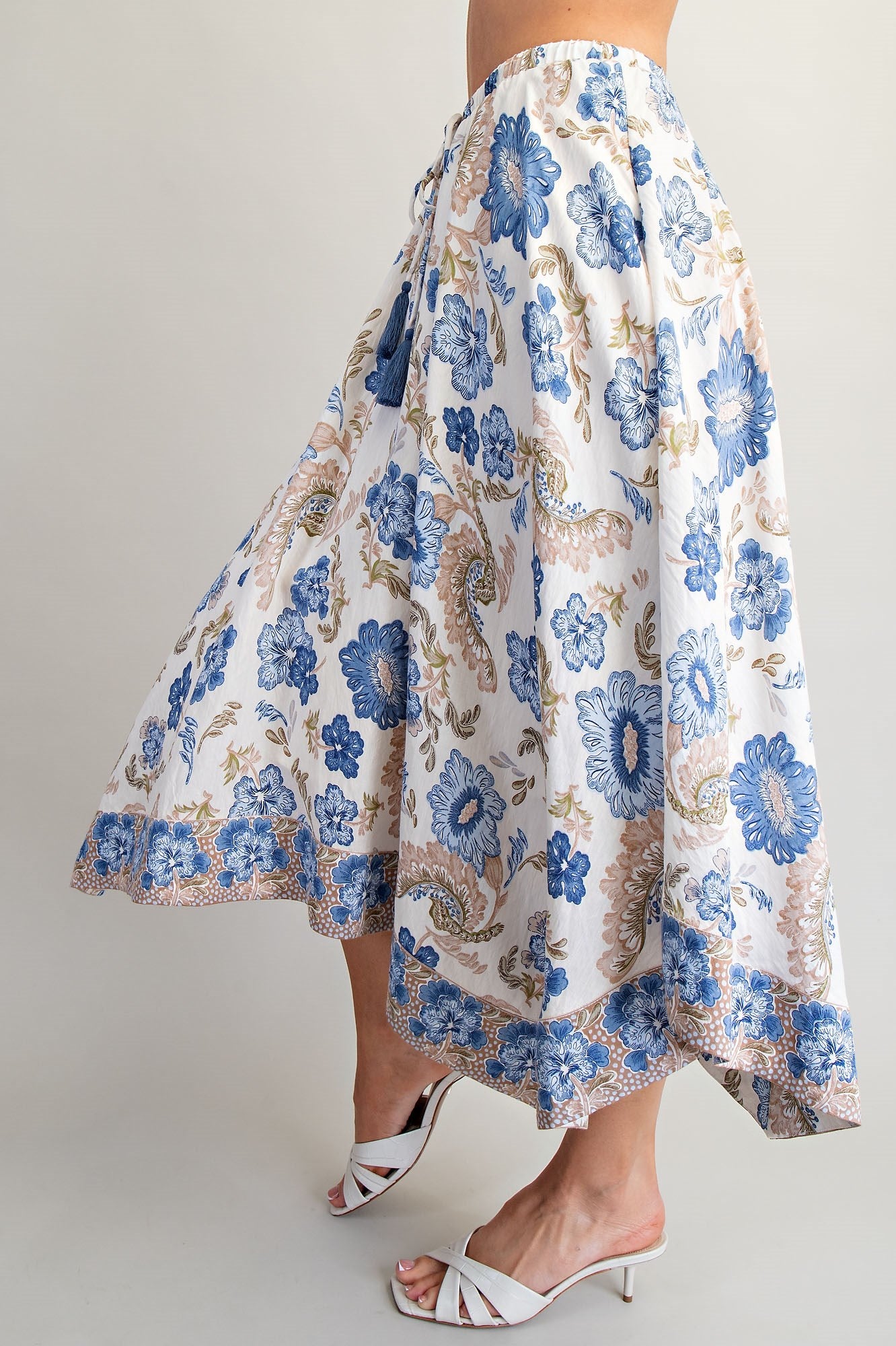 Floral patterned skirt with blue flowers on a plain background
