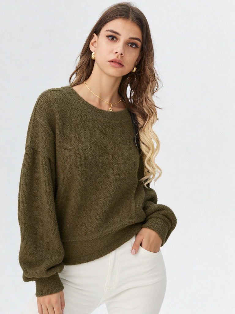 Woman in a olive round-neck textured knit oversized top with drop shoulders and long sleeves, relaxed fit
