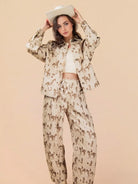 Woman wearing a beige outfit with horse print on a beige background