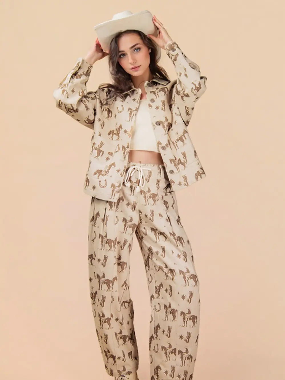 Woman wearing a beige outfit with horse print on a beige background