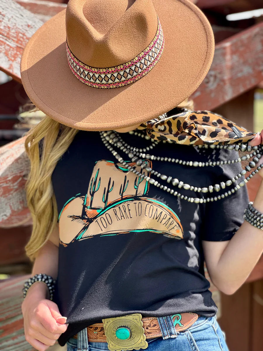 Black shirt sleeve crew neck tee with a brown cowboy hat and Too Rare to Compare on the hat and cactus