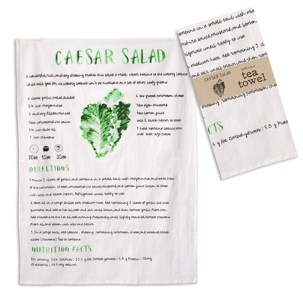 Caesar salad recipe on a tea towel with a matching tea towel on a white background
