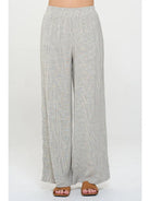 Light gray pin stripped pants worn with elastic  waist by a person 