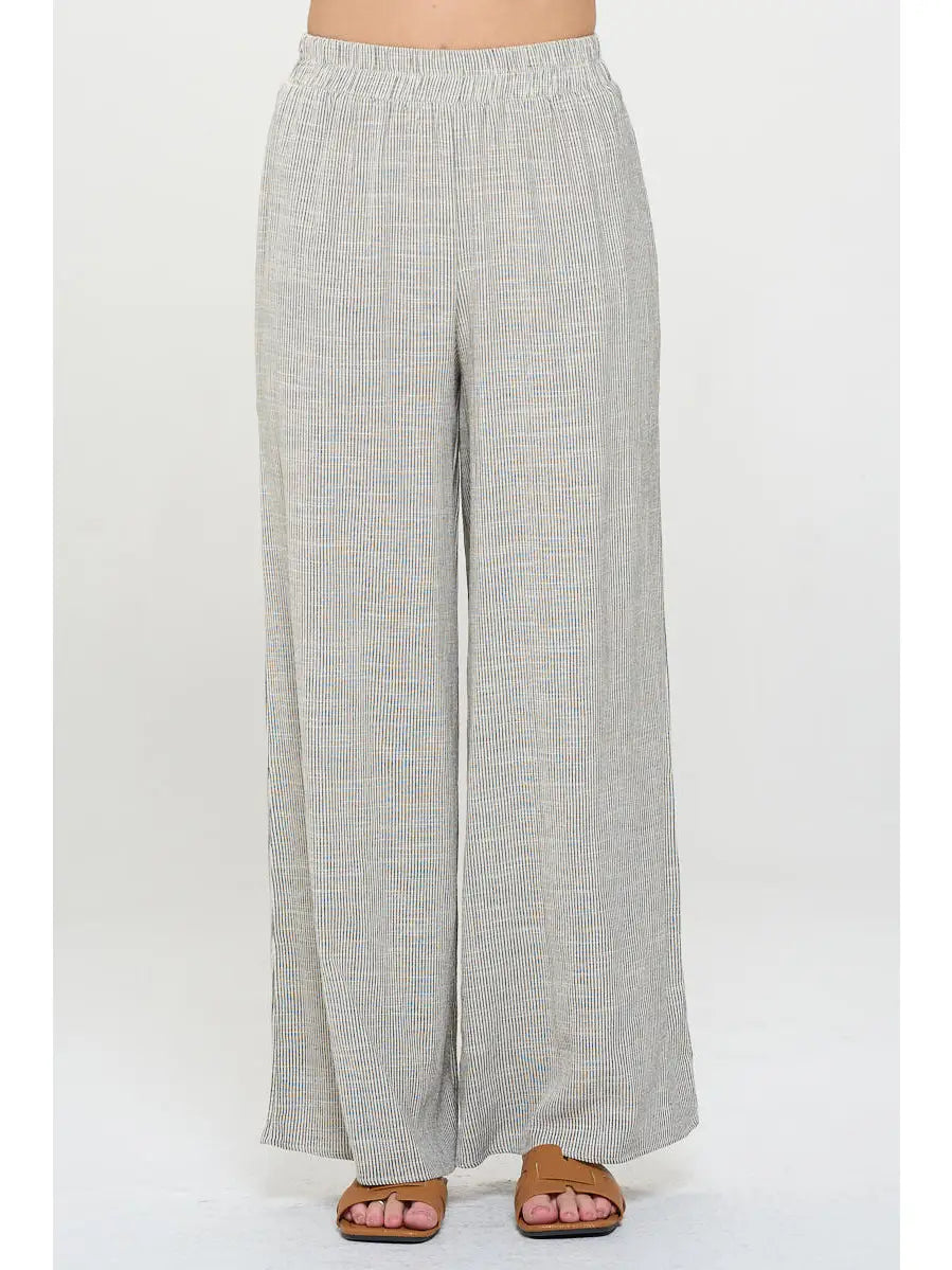 Light gray pin stripped pants worn with elastic  waist by a person 