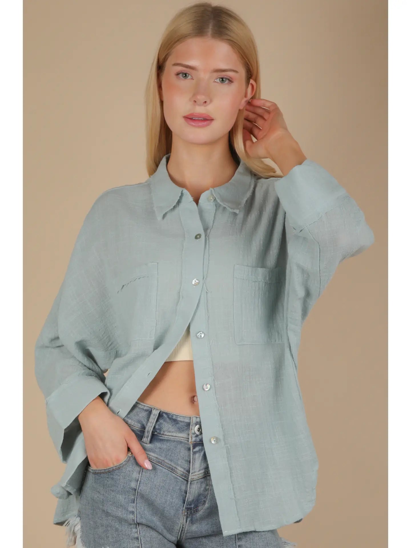 Front view of sky blue dolman-sleeve gauze button-down with patch pockets