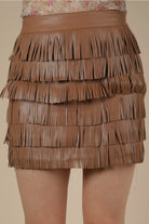 Brown vegan leather fringe mini skirt with layered tiers, front view on model