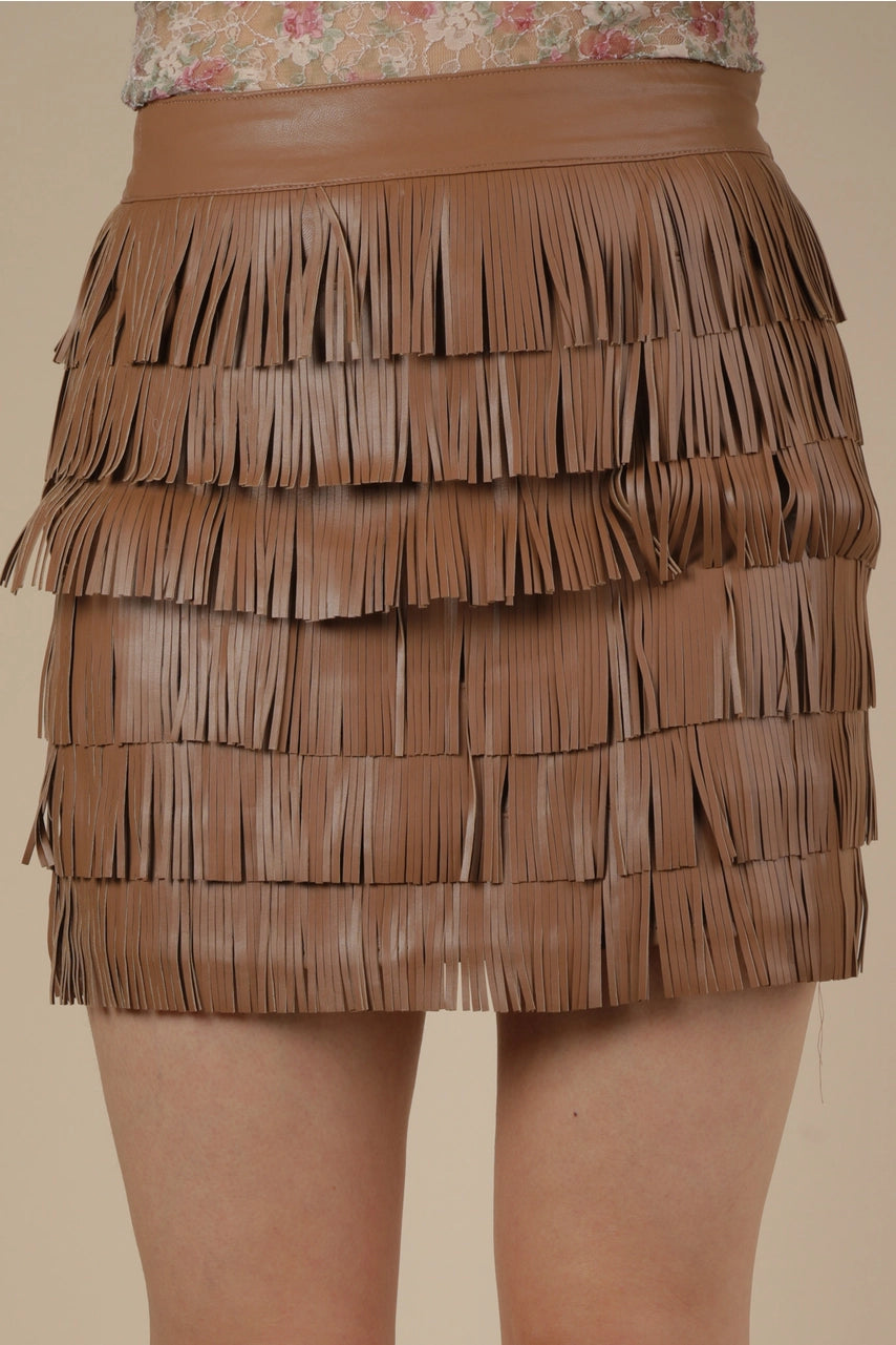Brown vegan leather fringe mini skirt with layered tiers, front view on model