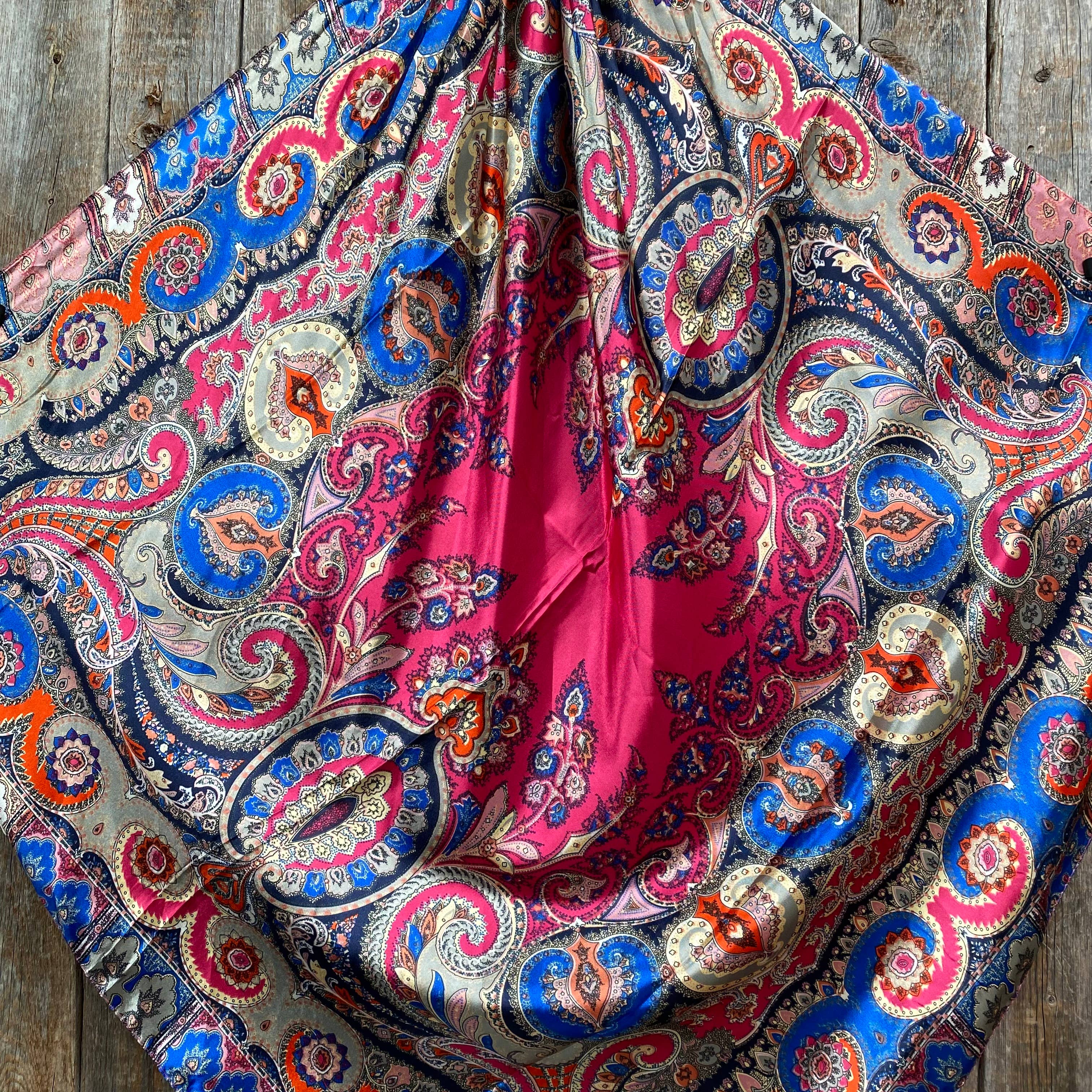 Colorful paisley patterned fabric on a wooden surface