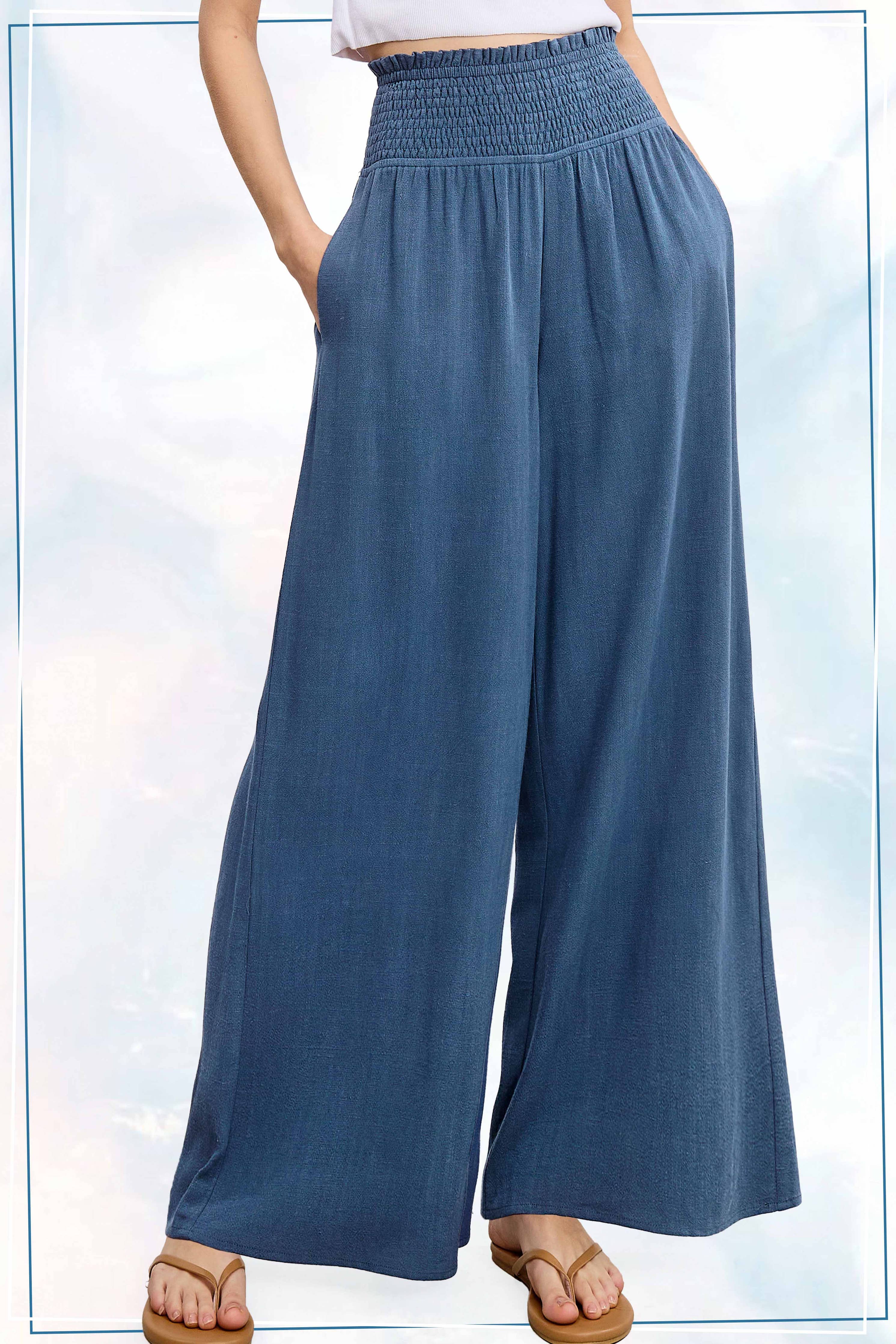 Blue wide-leg pants worn by a person on a light blue background