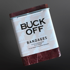 Can of Buck Off bandages with a brown lid and leather-like bottom on a dark background