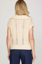 Back view of Woman wearing a beige knitted vest top short sleeve 