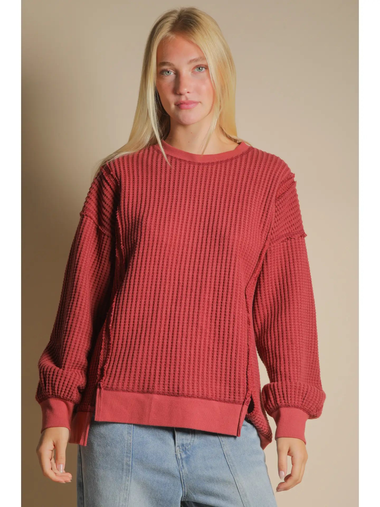 Front view of burgundy oversized waffle knit top with round neck and drop shoulders.