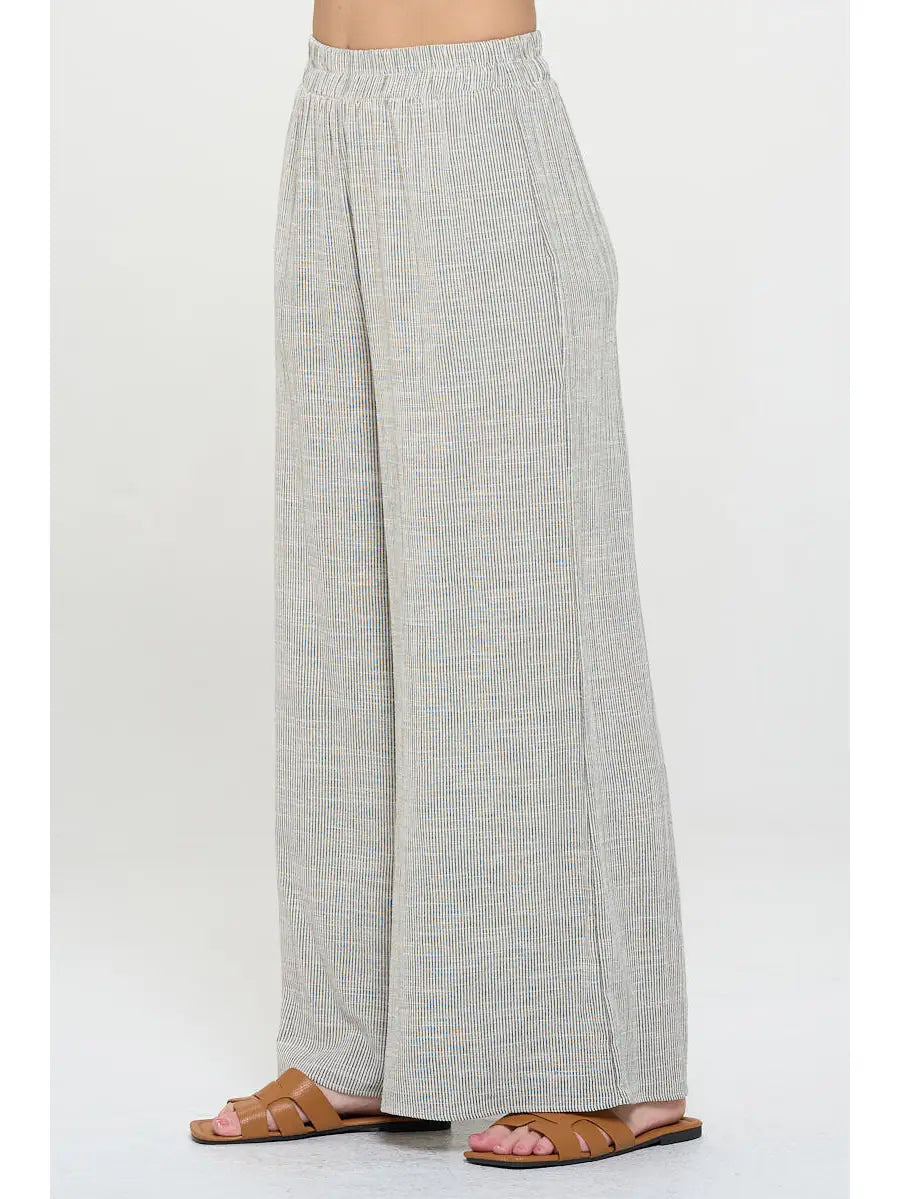 Light gray pin stripped pants worn with elastic  waist by a person 