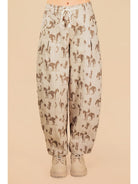 Light-colored pants with horse pattern on a beige background