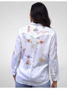 White embroidered shirt worn by a person on a plain background