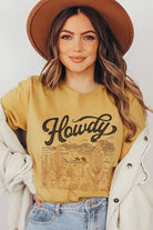 Mustard yellow Bella + Canvas graphic tee featuring a vintage "Howdy" western design with a desert landscape, cacti, and relaxed unisex fit.