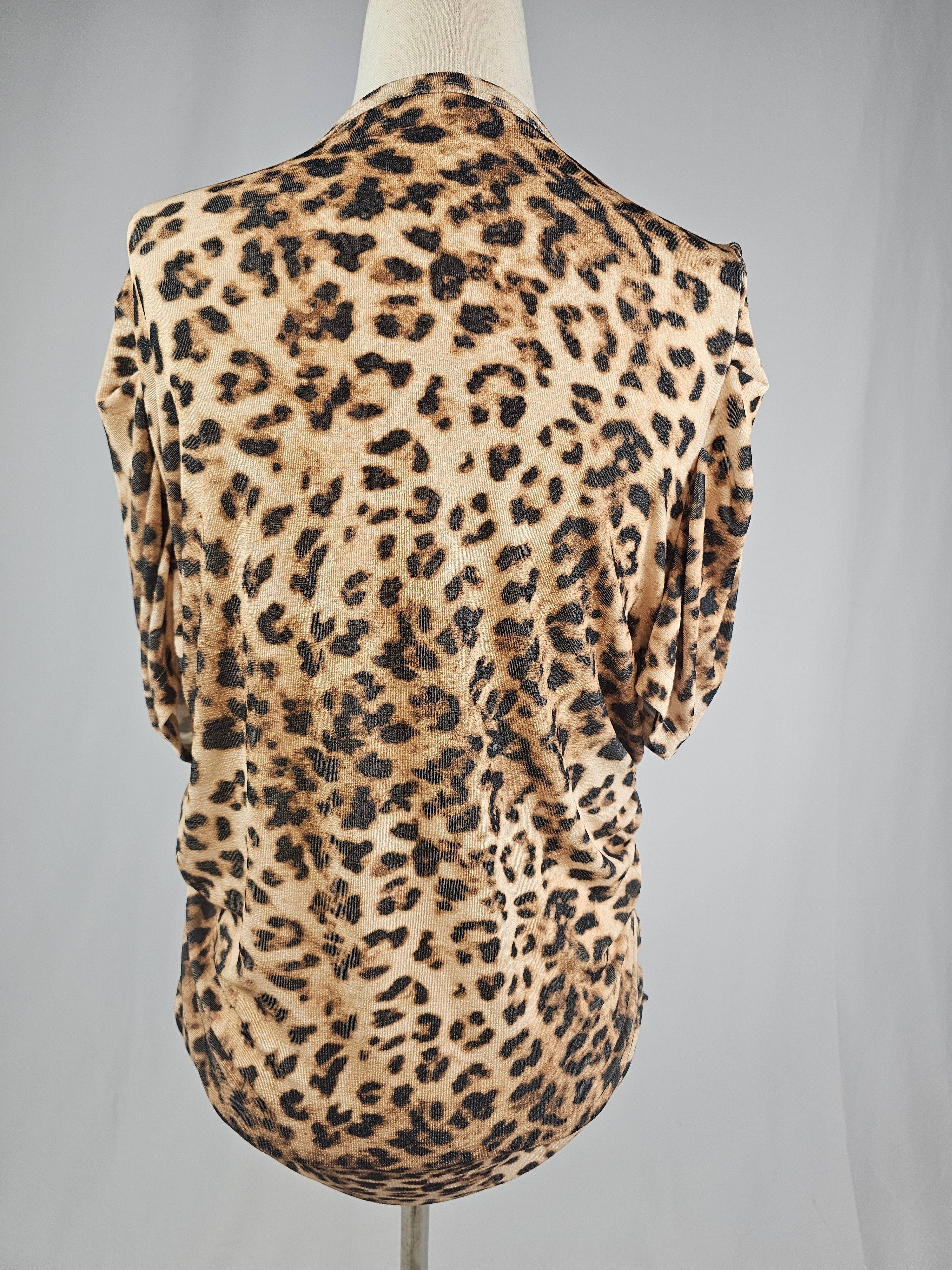 Leopard print sleeveless top on a mannequin against a gray background