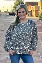 Black and white toole pattern on a ribbed long sleeve top