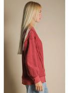Side angle showing front slit and relaxed drape of waffle knit pullover
