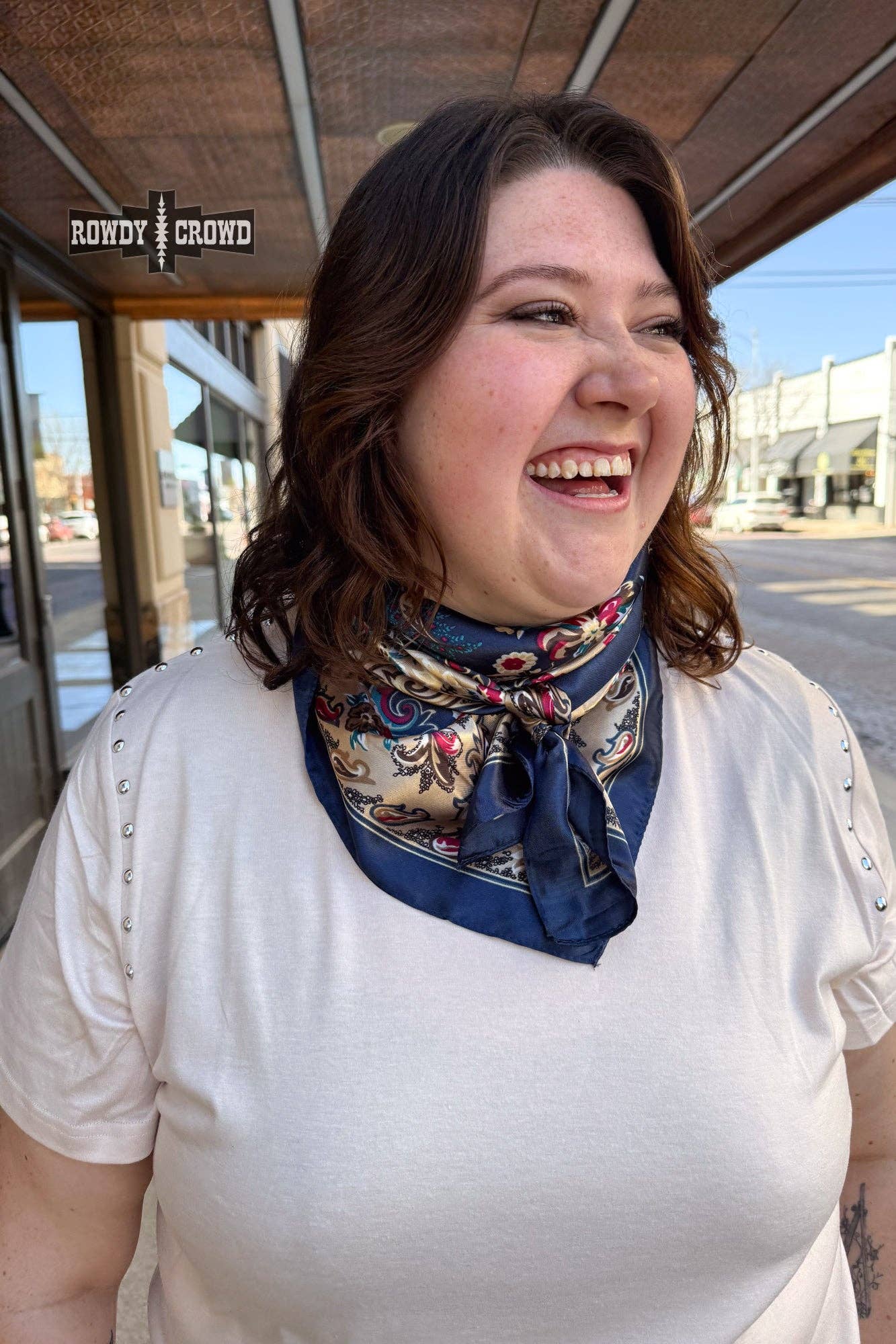 Woman wearing a patterned scarf in an outdoor setting