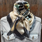 Person wearing a floral scarf on a wooden background