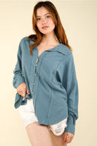 Model in dusty-blue striped linen-blend shirt, front angle; button front, chest pocket, drop shoulders, long sleeves.”