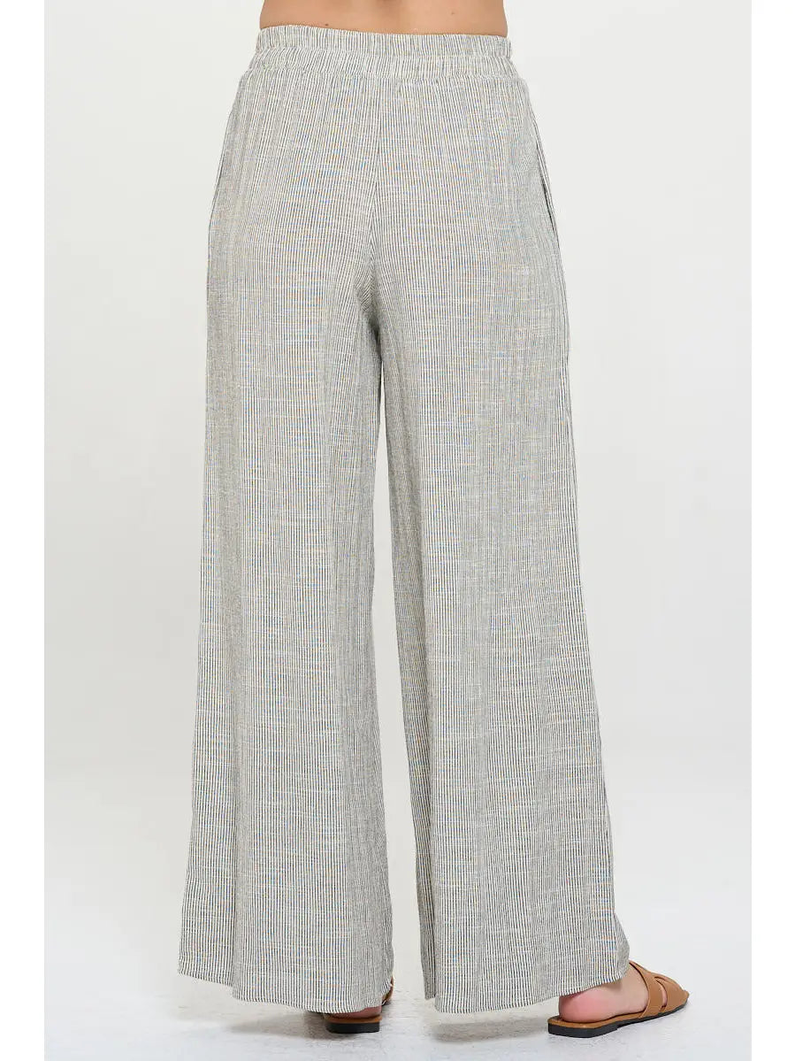 Light gray pin stripped pants worn with elastic  waist by a person 