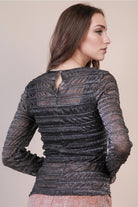 Back view: Close-up of the black sparkle mesh top showing back keyhole button closure and silver shimmer texture.
