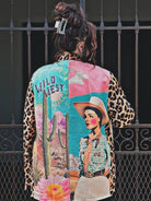 Colorful patchwork jacket with a cowboy design and 'Wild West' text, worn by a person.