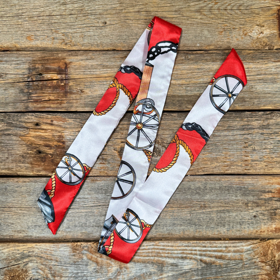 Thin scarf with  red and white patterned on a wooden surface