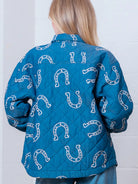 Back view highlighting overall horseshoe pattern on blue quilted coat.