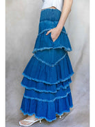Blue tiered skirt worn by a person on a plain background