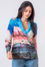 Woman wearing a colorful blazer with a neutral background