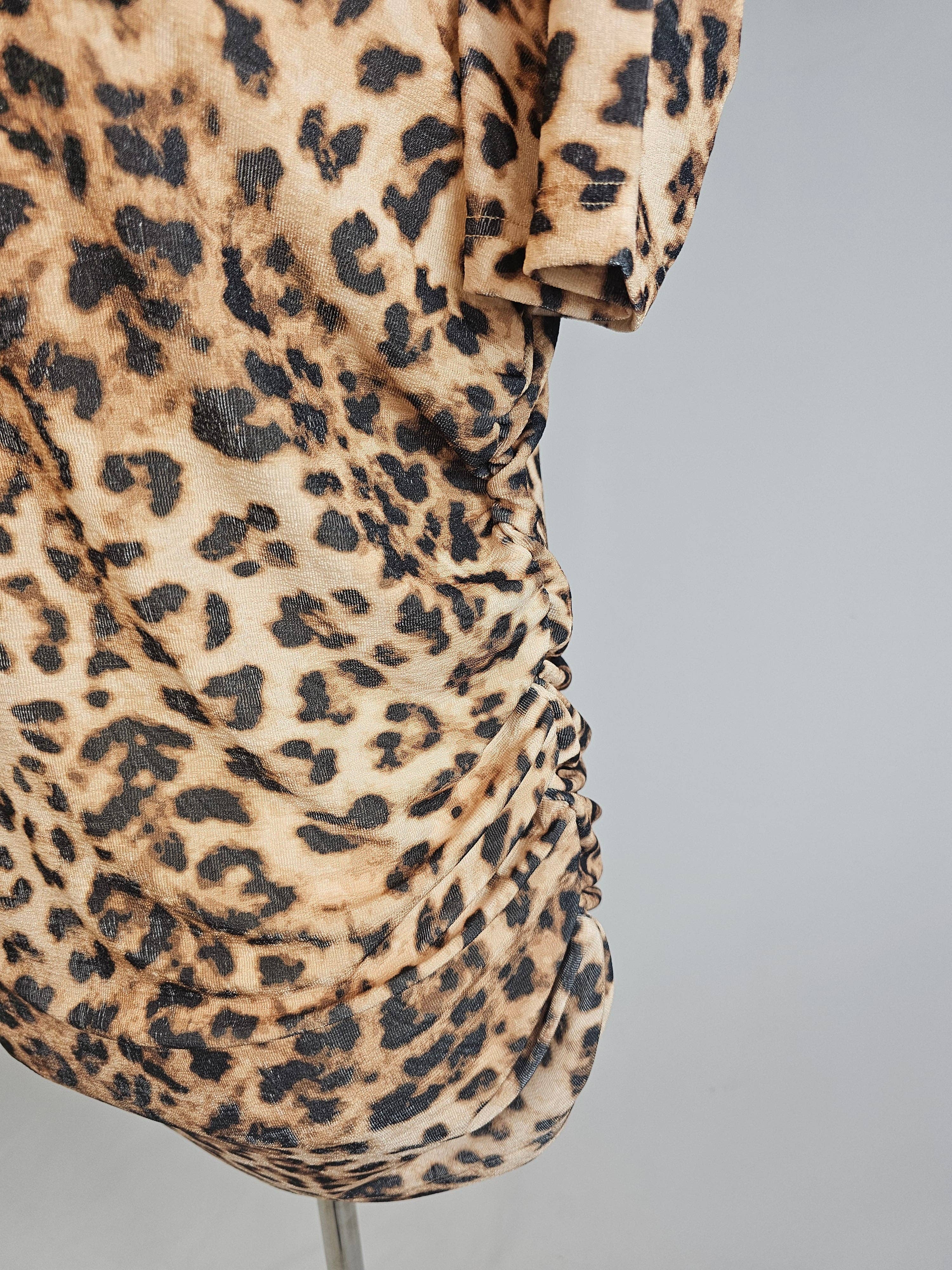 Leopard print dress on a mannequin against a gray background