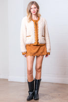 Front view of taupe Western sherpa jacket with zig-zag faux-suede trim on model