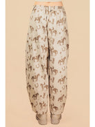 Beige pants with horse pattern on a beige background