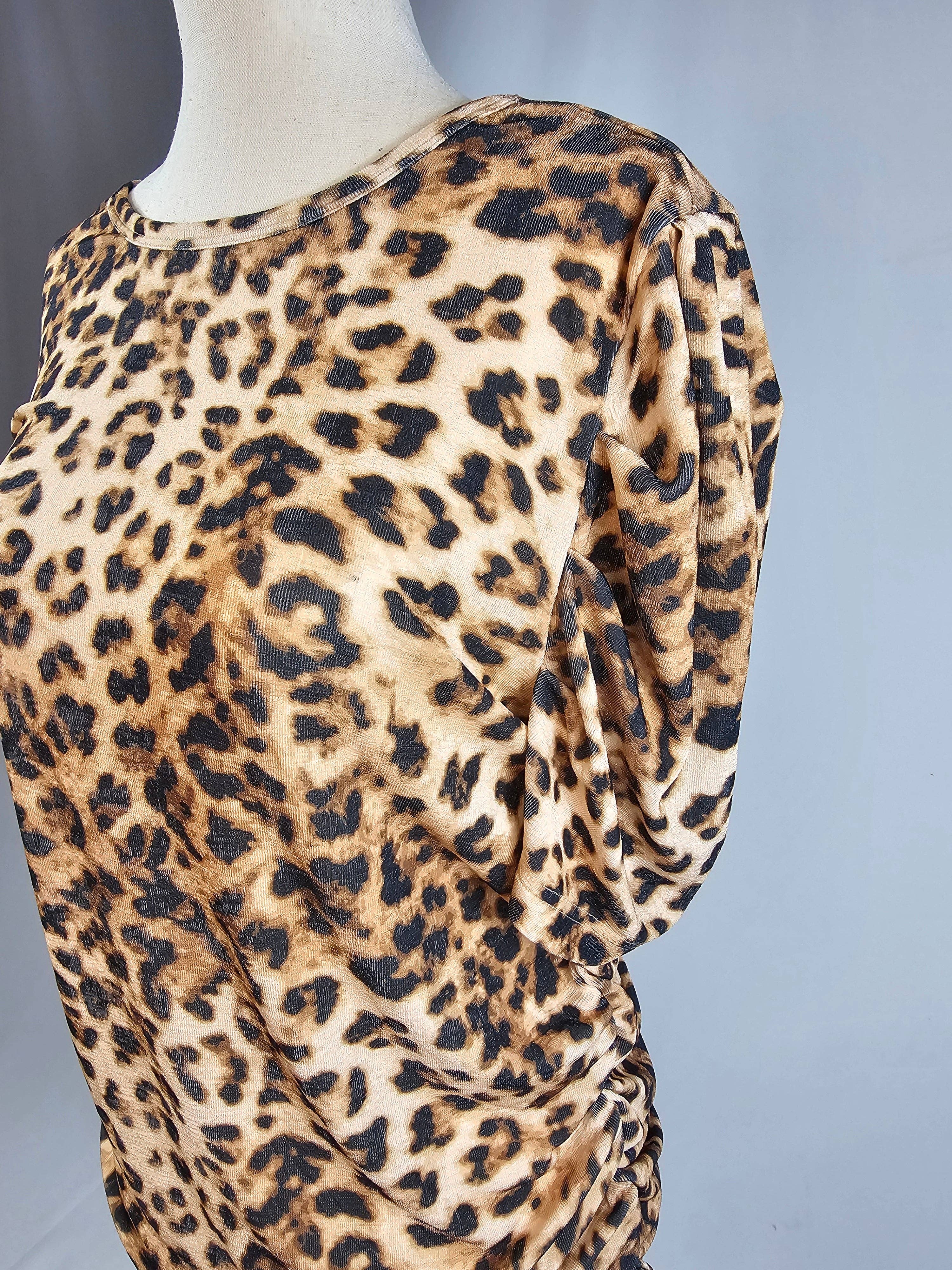Leopard print dress on a mannequin against a gray background