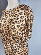 Leopard print dress on a mannequin against a gray background