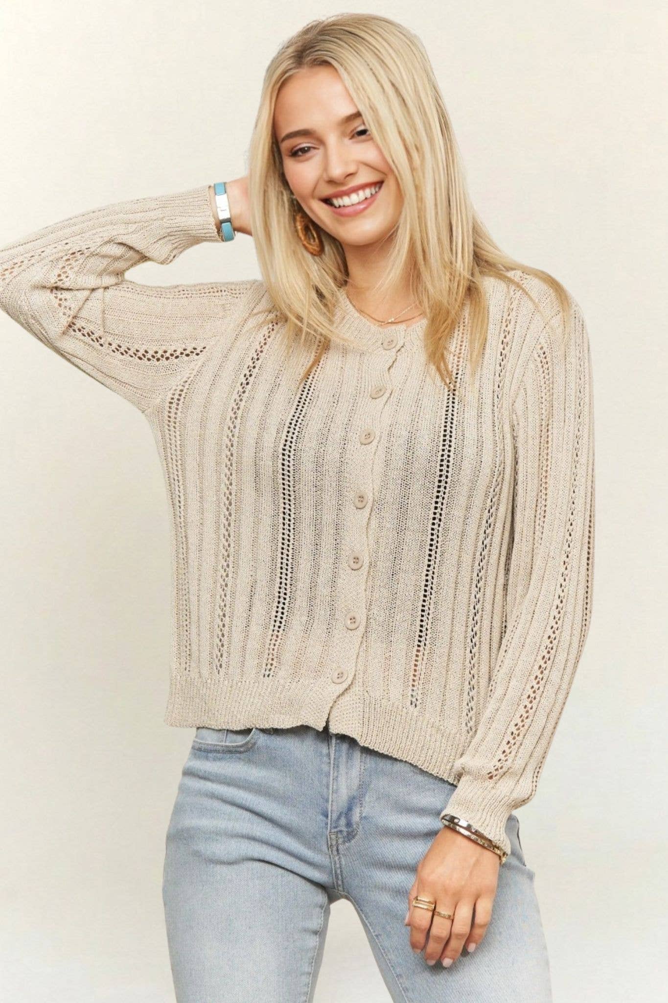 Lightweight cream open-knit cardigan featuring a button-front closure, crew neckline, vertical ribbed crochet detailing, and long sleeves for effortless layering.