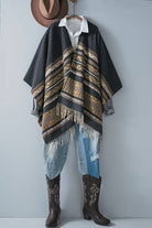 Dark gray poncho with brown and beige striped pattern and fringes on a white background