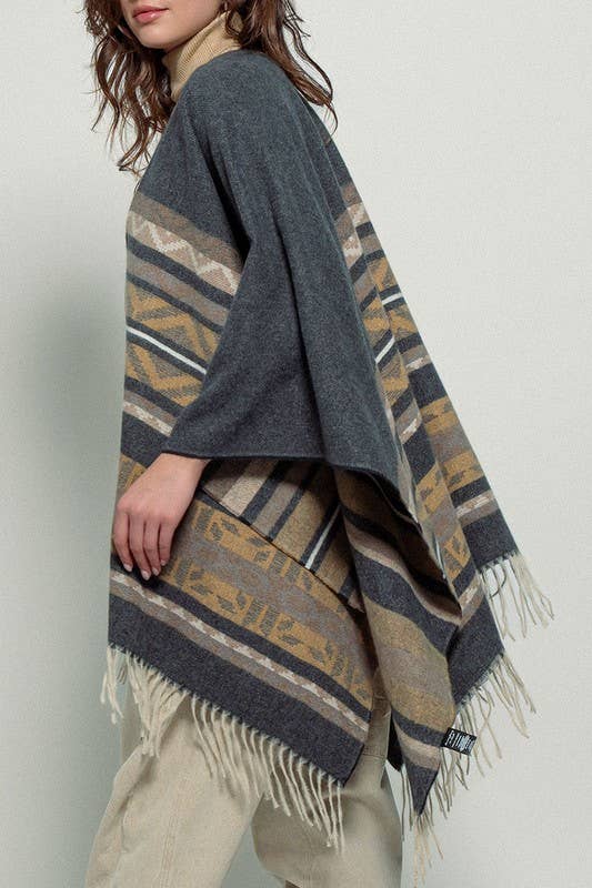 Dark gray poncho with brown and beige striped pattern and fringes on a white background