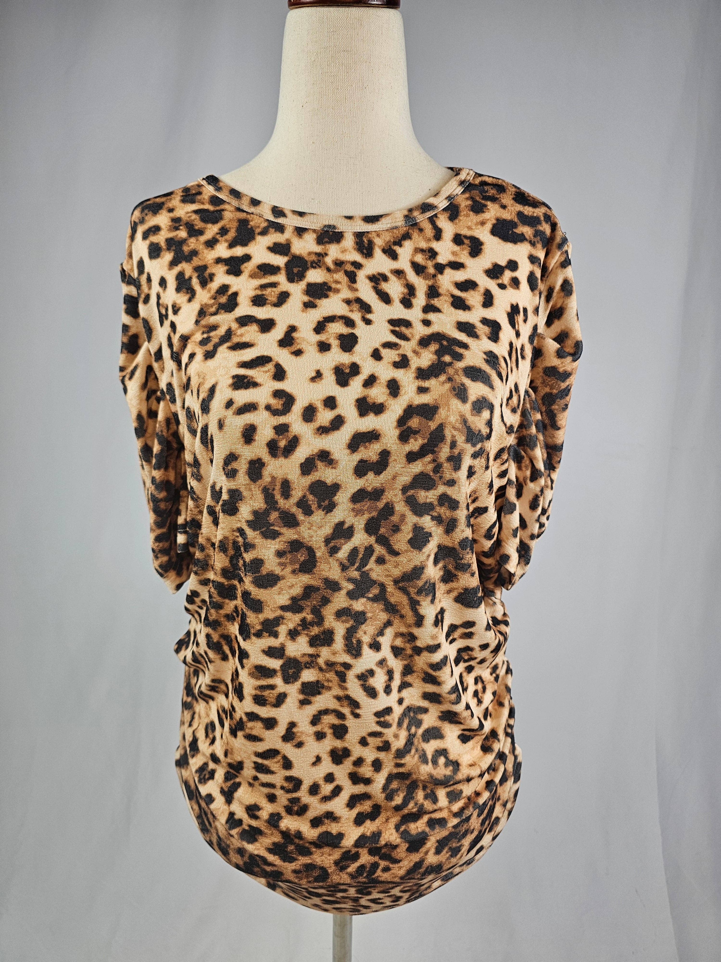 Leopard print top on a mannequin against a gray background