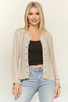 Lightweight cream open-knit cardigan featuring a button-front closure, crew neckline, vertical ribbed crochet detailing, and long sleeves for effortless layering.